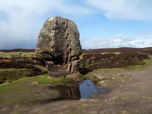 The Cork Stone one of a number of impressive outcrops dotted around Stanton Moor. Its weathered sandstone resembling a cork. It has steps cut into the rock to enable easy ascent and is covered in graffiti