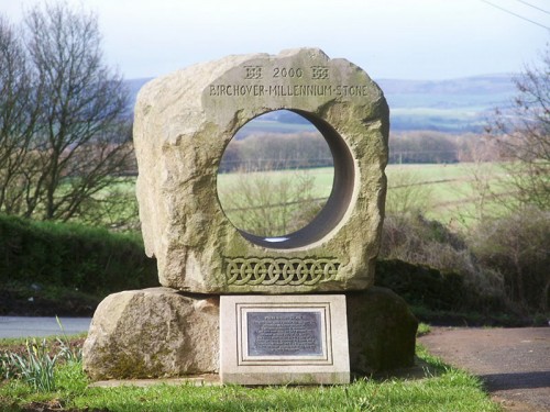 Birchover Millennium Stone - Sited opposite the Druid Inn, the local quarry donated the stone and Mark Eaton carried out the carving. The stone is approximately a ton and a half in weight